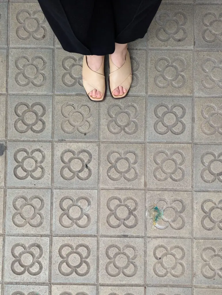 Woman’s feet walking along a pavement